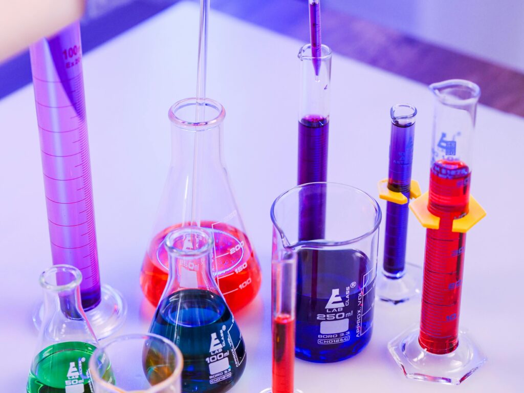 Vivid colored liquids in laboratory glassware for scientific research.